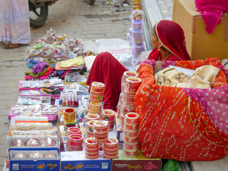 Rural Indian village woman selling bangles. Display of Colorful Bangles for wearing in hand by women, female, girls in India.のeditorial素材