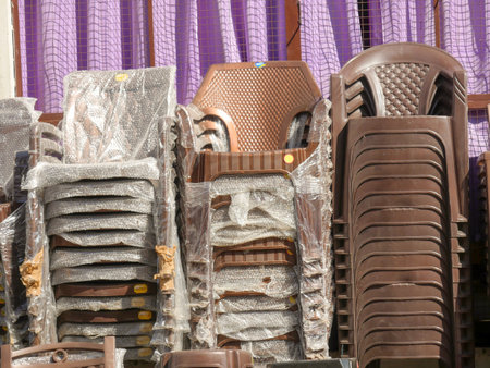 Pushkar, Rajasthan / India - November 5, 2019 : Piles of plastic chairs ready to be sell in market.のeditorial素材