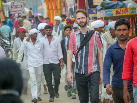 Pushkar, Rajasthan / India - November 5, 2019 : Street market in rural India. Crowded busy Street with men and women walking in Rural Indian Town at Pushkar city Indiaのeditorial素材