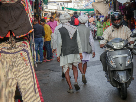 Pushkar, Rajasthan / India - November 5, 2019 : Street market in rural India. Crowded busy Street with men and women walking in Rural Indian Town at Pushkar city Indiaのeditorial素材