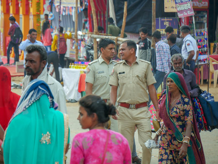 Pushkar, Rajasthan / India - November 5, 2019 : Street market in rural India. Crowded busy Street with men and women walking in Rural Indian Town at Pushkar city Indiaのeditorial素材