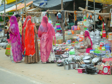 Pushkar, Rajasthan / India - November 5, 2019 : Indian rural village area street market, stall sellers selling various items.のeditorial素材