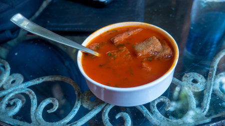 Tomato soup with toast pieces.