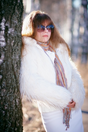 The beautiful girl in dark glasses in white clothesの写真素材