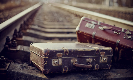 Two old fashioned suitcases on the railway.の写真素材