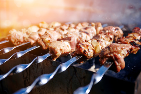 Smoky grilling the marinated pork meat delicious shashlikの写真素材