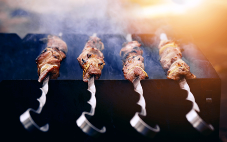 Smoky grilling the marinated pork meat delicious shashlikの写真素材