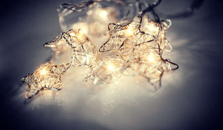 Christmas luminous garland in the shape of stars from LED bulbs. Glowing stars made of wire.の写真素材