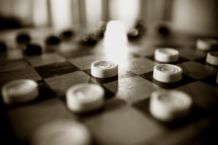 A chessboard with black and white checkers. A logic game with checkers.