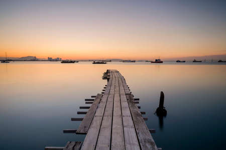 Long exposure old fisherman jetty during sunriset. Soft focus due to long exposure shot. Nature composition.の写真素材