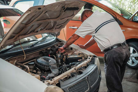 Segamat, Malaysia - November 11th , 2017 : Automobile air-conditioner servicing. Mechanic checking cooling system in car engine.のeditorial素材