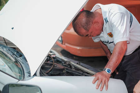 Segamat, Malaysia - November 11th , 2017 : Automobile air-conditioner servicing. Mechanic checking cooling system in car engine.のeditorial素材