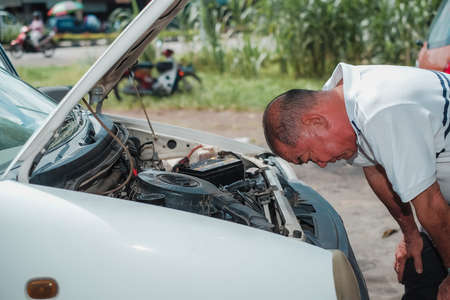 Segamat, Malaysia - November 11th , 2017 : Automobile air-conditioner servicing. Mechanic checking cooling system in car engine.のeditorial素材