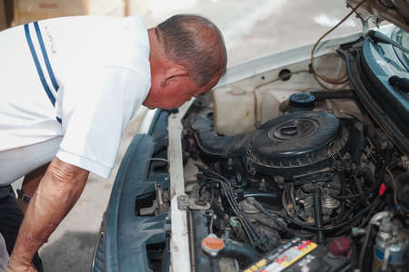 Segamat, Malaysia - November 11th , 2017 : Automobile air-conditioner servicing. Mechanic checking cooling system in car engine.のeditorial素材