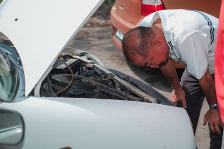 Segamat, Malaysia - November 11th , 2017 : Automobile air-conditioner servicing. Mechanic checking cooling system in car engine.のeditorial素材