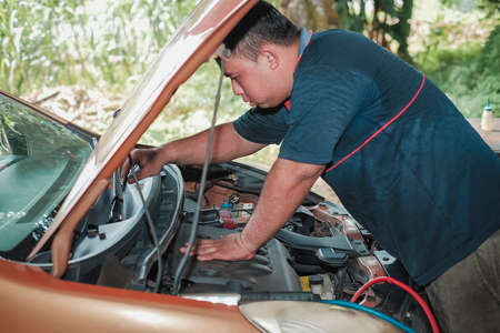 Segamat, Malaysia - November 11th , 2017 : Automobile air-conditioner servicing. Mechanic uninstall cooling coil and filter  in the old car.の写真素材