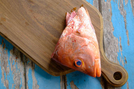 Fresh red snapper on wooden cutting board .の写真素材