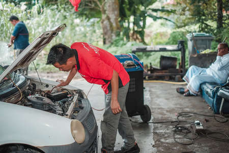 Segamat, Malaysia - November 11th , 2017 : Automobile air-conditioner servicing. Mechanic uninstall cooling coil and filter  in the old car.のeditorial素材