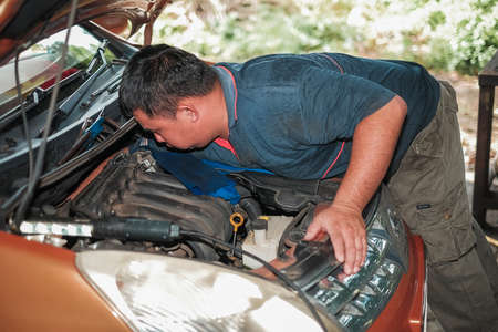 Segamat, Malaysia - November 11th , 2017 : Automobile air-conditioner servicing. Mechanic uninstall cooling coil and filter  in the old car.のeditorial素材
