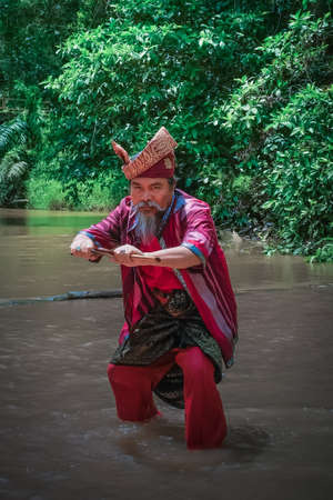 Kuantan, Malaysia - October 21st, 2017 : A Malay man with his keris and  the traditional malay warrior costume performing stepsのeditorial素材