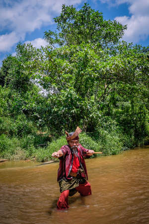 Kuantan, Malaysia - October 21st, 2017 : A Malay man with his keris and  the traditional malay warrior costume performing stepsのeditorial素材