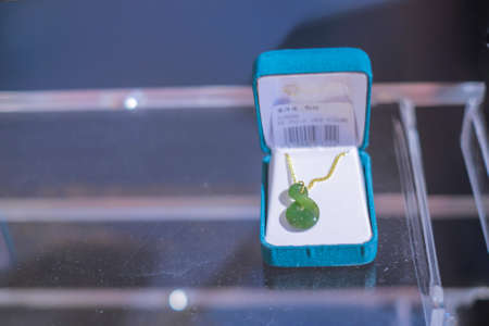 Christchurch, New Zealand â December 19th, 2017 :  Maori New Zealand Greenstone pounamu jade Koru (spiral fern) shape pendant for sale in souvenir shop.のeditorial素材