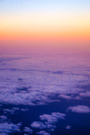 Beautiful view  of cumulus clouds with sunset at atmosfera from airplain window. Blurred imageの写真素材