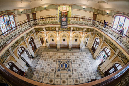 Dunedin, New Zealand â December 18th, 2017 : The interior of Dunedin Railway Station completed in 1907 and featuring a Royal Doulton mosaic floor with decorative wrought iron railings running around the gallery aboveのeditorial素材