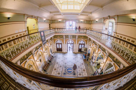 Dunedin, New Zealand â December 18th, 2017 : The interior of Dunedin Railway Station completed in 1907 and featuring a Royal Doulton mosaic floor with decorative wrought iron railings running around the gallery aboveのeditorial素材