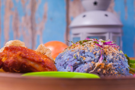 Fried chicken with rice and a combination of vegetables, duck eggs and ingredients in the plate