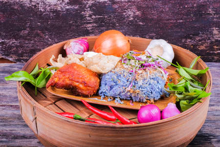 Fried chicken with rice and a combination of vegetables, duck eggs and ingredients in the plateの写真素材