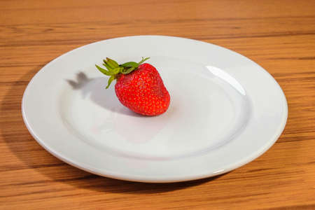 Fresh strawberry on a white plateの写真素材