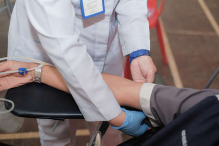 Muadzam Shah,  Malaysia - February 21st, 2018 : Unidentified hospital staff holding blood pint donated by volunteer donor during blood donation campaign.のeditorial素材