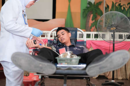 Muadzam Shah,  Malaysia - February 21st, 2018 : Unidentified man in blood donation chair during blood donation campaignのeditorial素材