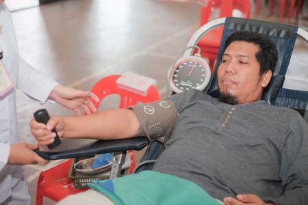 Muadzam Shah,  Malaysia - February 21st, 2018 : Unidentified man in blood donation chair during blood donation campaignのeditorial素材