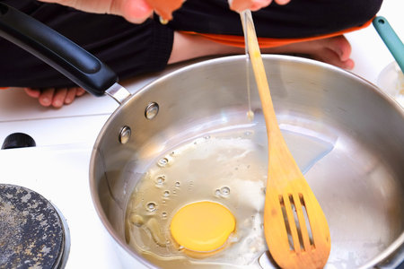 Close up view of the fried egg on a frying pan for cooking rice friedの写真素材