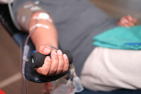 Muadzam Shah,  Malaysia - February 21st, 2018 : Unidentified hospital staff arms sticking needle into male arm during blood donation campaign .のeditorial素材