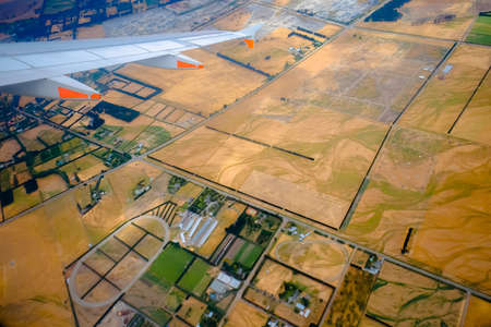 Beautiful landscape green field views from an airplane window during depart at Christchurch International Airport, Canterbury, New Zealand's South Islandの写真素材