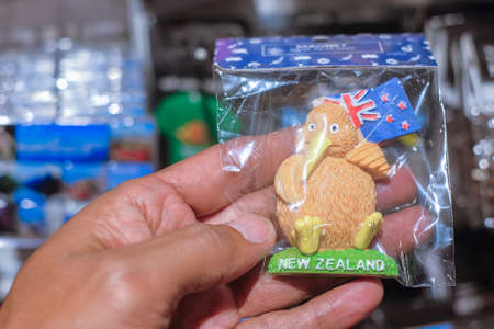 CHRISTCHURCH , NEW ZEALAND - DECEMBER 19th ,2017 : Man holding kiwi souvenir for sale in DF Souvenir.のeditorial素材