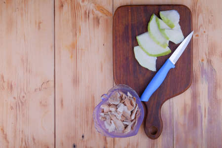 Sour orange peel and sliced guava on cutting board.の写真素材