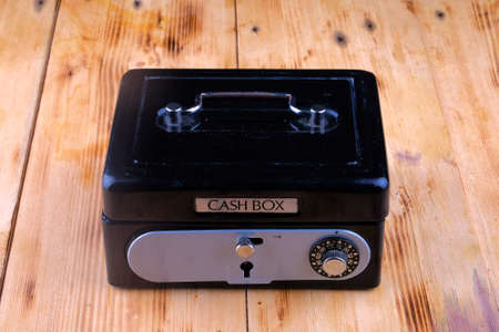 Cash box on the wooden tableの写真素材