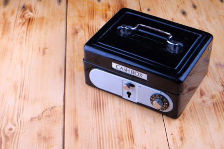 Cash box on the wooden tableの写真素材