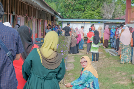 Muadzam Shah, Malaysia - May 9th, 2018: Malaysian voters line up to vote at the election center...