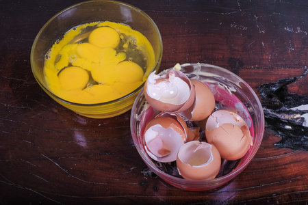 Egg in the glass bowl for making red velvet cake. Food and cooking concept.