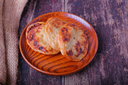 Akok Kedut on wooden plate over the wooden table. Akok Kedut is a traditional dish in Malaysia...