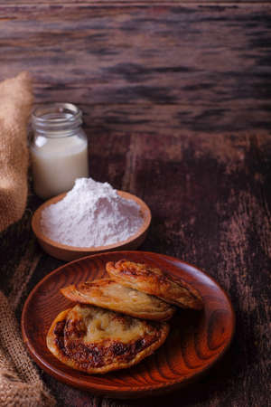Akok Kedut, egg, coconut, flour , coconut milk and  Pandan leaf on wooden background. Akok Kedut is a traditional dish in Malaysia especially East Coast.の写真素材