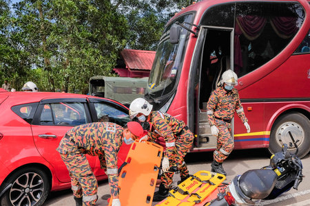Muadzam Shah, Malaysia - October 18th, 2018 : Firefighter rescuing wounded young man in accident...