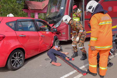 Muadzam Shah, Malaysia - October 18th, 2018 : Firefighter rescuing wounded young man in accident...