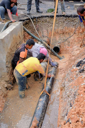 Muadzam Shah, Malaysia - November 1st, 2018  : Construction workers installing new pipe at the construction siteのeditorial素材