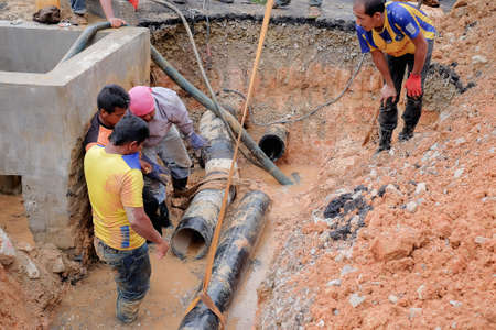 Muadzam Shah, Malaysia - November 1st, 2018  : Construction workers installing new pipe at the construction siteのeditorial素材
